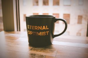 Eternal optimist coffee mug.
