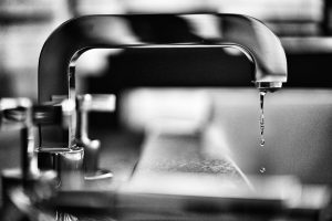 A black and white photo of a faucet.