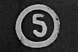 A black and white photo of the number five.