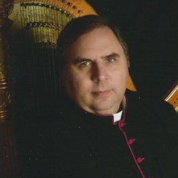 Msgr. Louis Marucci posing with a harp.